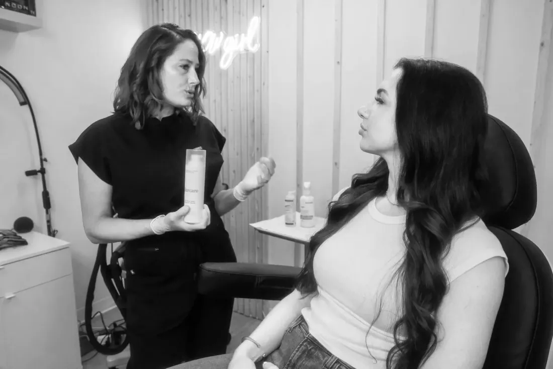 A Glow Med Spa provider talking a client through her skin care